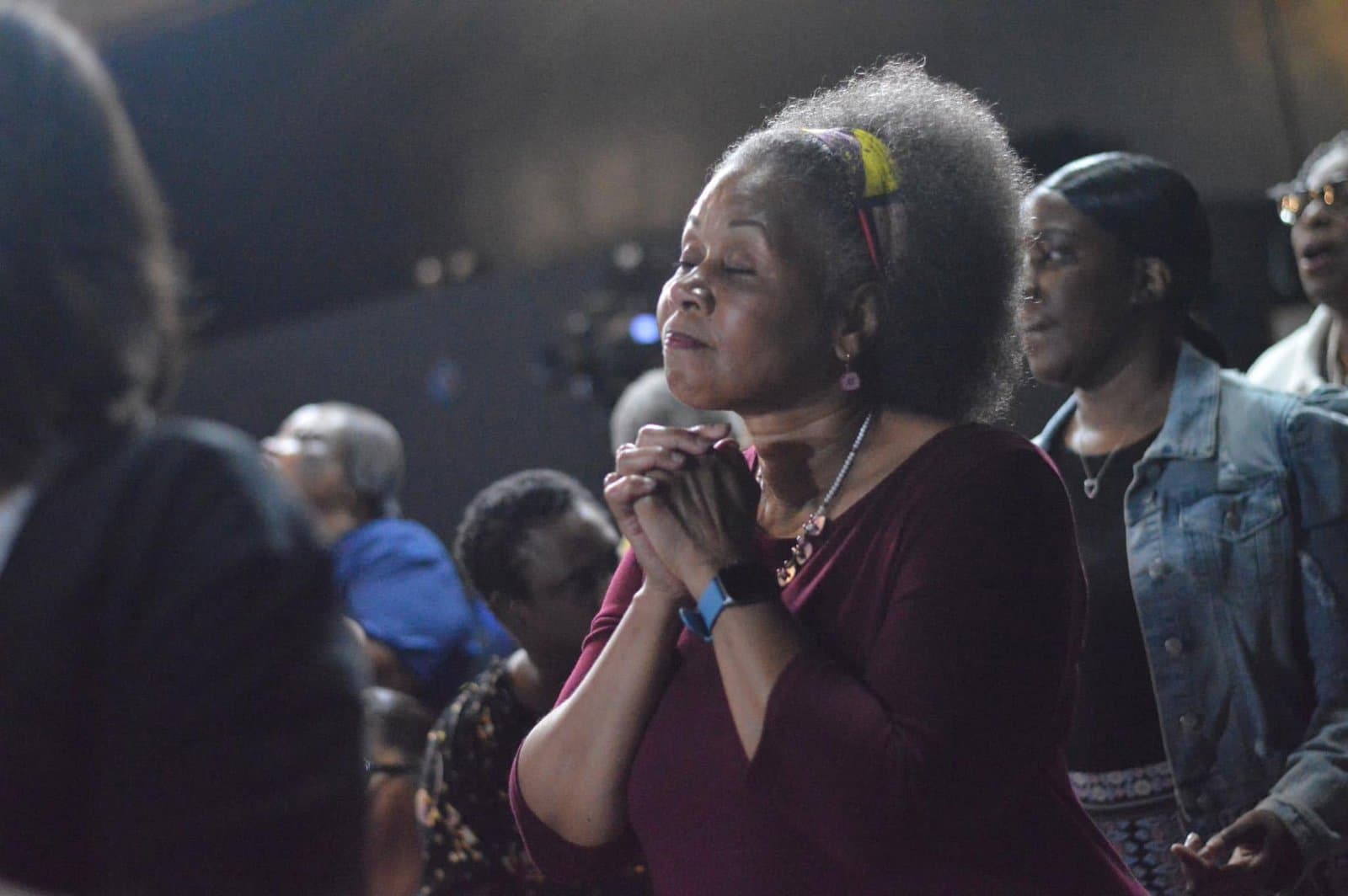 A member of NGBM in prayer during service